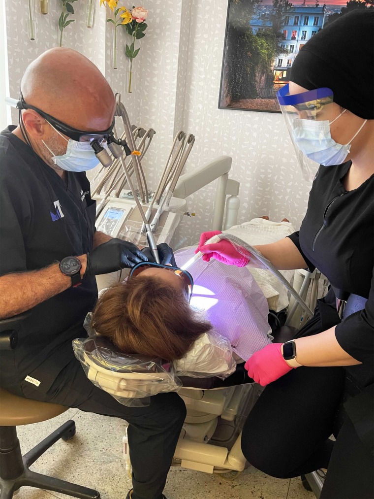 Dr. Ramin Tabib performs a procedure on a patient on June 16, 2021, at NYC Smile Design in New York City.