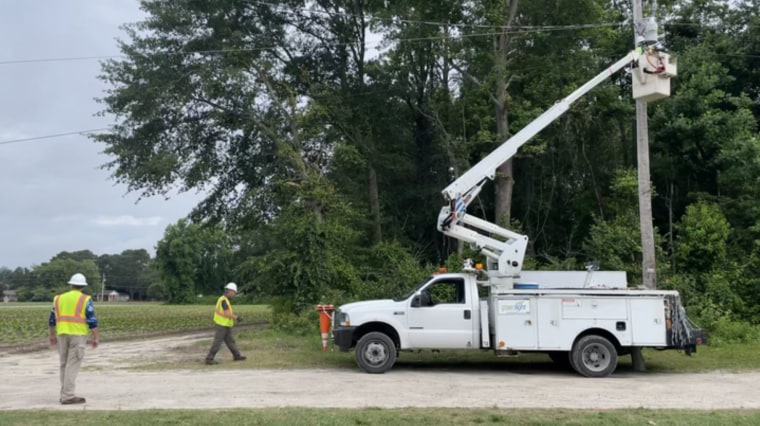 Workers with Greenlight Community Broadband run fiber optic cable in rural Wilson County, North Carolina