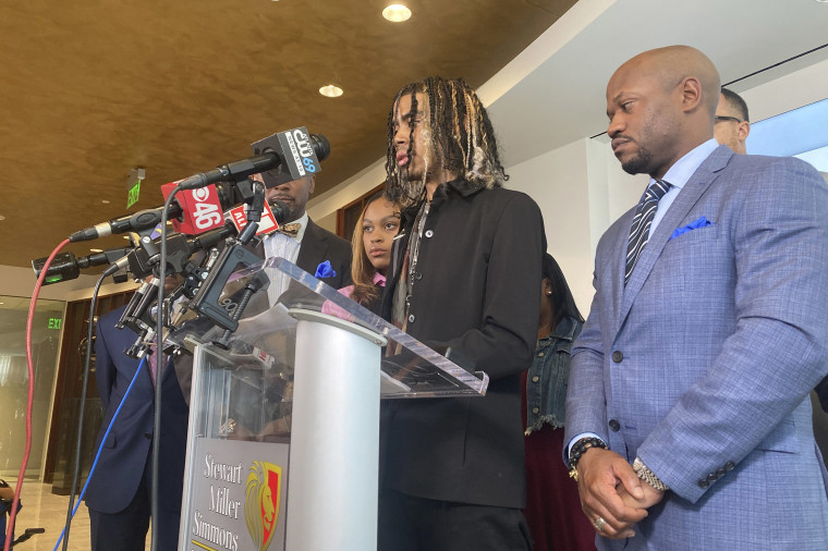 Image: Messiah Young speaks during a news conference accompanied by attorney L. Chris Stewart, right, who represents plaintiff Taniyah Pilgrim, background center, in Atlanta