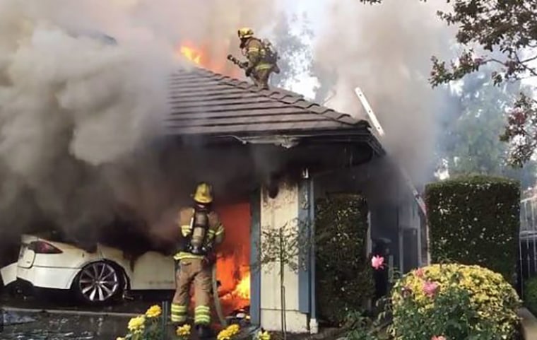 Firefighters battle a blaze sparked by a Tesla in Lake Forest, Calif., on Aug. 25, 2017.