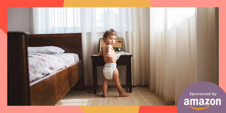 Portait of a 1 year old boy in a diaper in a bedroom