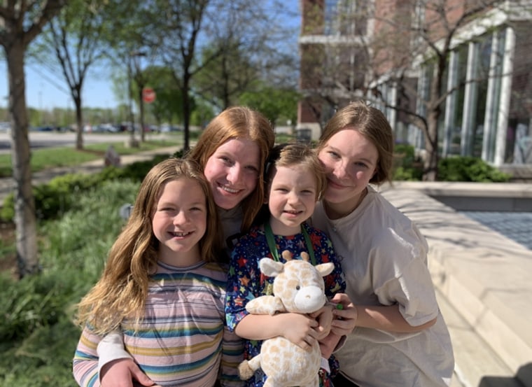 Vera poses for a photo with her three older sisters. 