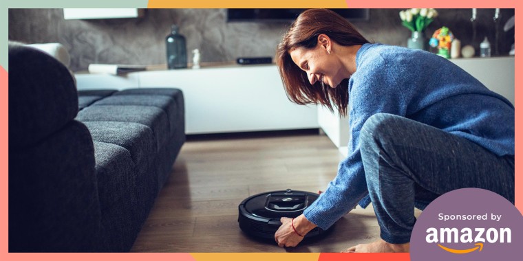 Woman holding a robot vacuum in her living room