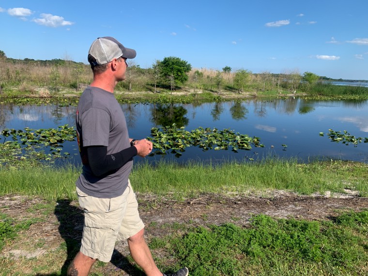 Carsten Kieffer at the central Florida lake where an alligator attack nearly cost him his life.