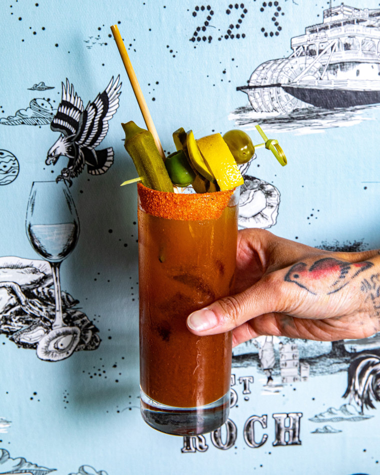 Esther Wallace, general manager of St. Roch Fine Oysters in Raleigh, adds pickle brine to her bloody marys.