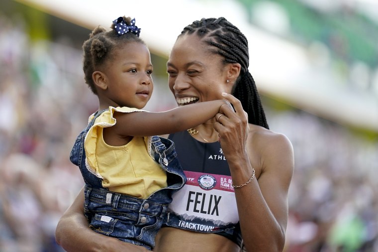 Allyson Felix celebrates after her second place finish in the women's 400-meter run with her daughter Camryn at the U.S. Olympic Track and Field Trials on June 20, 2021, in Eugene, Ore.