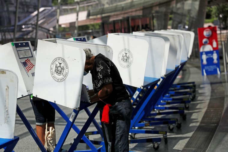 People fill out ballots at the Brooklyn Museum during early voting for the primary election in New York on June 16, 2021.