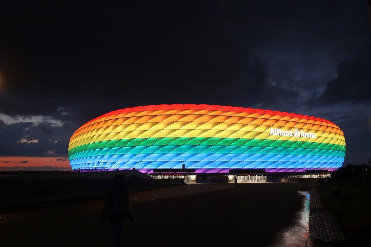 Image: The outside of the soccer stadium Allianz Arena which is illuminated in rainbow colors