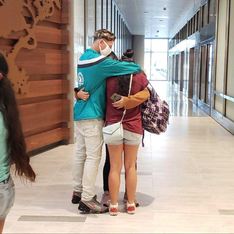 Yudissa hugs her son and daughter on Sunday in the airport in Tampa, Fla., where they reunited after years spent apart.