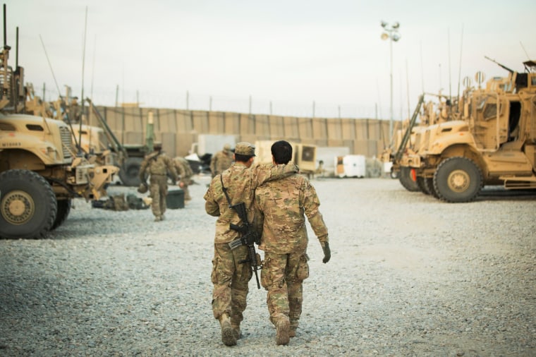 Image: FILE PHOTO: U.S. soldier from the 3rd Cavalry Regiment walks with the unit's Afghan interpreter before a mission near forward operating base Gamberi in the Laghman province of Afghanistan