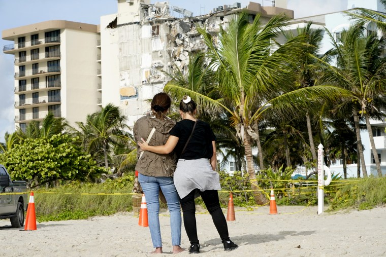Image: Maria Fernanda Martinez and Mariana Corderiro of Boca Raton, Fla., on Friday stand outside of a 12-story beachfront condo building that partially collapsed.