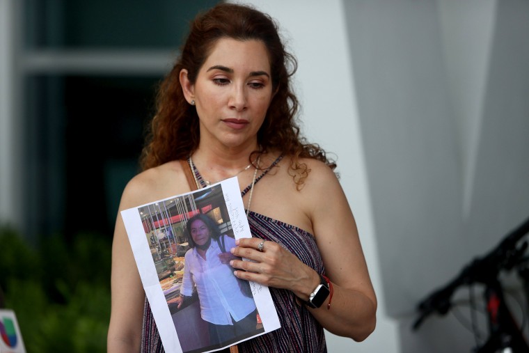 Image: Luz Marina holds a picture of her aunt, Marina Azen, who she said is missing after the partial collapse of the 12-story Champlain Towers South condo tower.