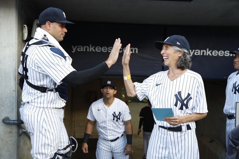 McLoughlin gives a high five to Yankees catcher Gary Sanchez.