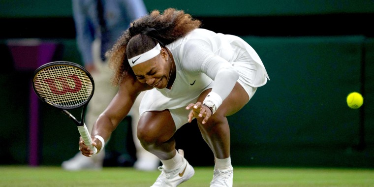 Serena Williams reacts as she pulls-up injured before withdrawing from her women's singles first round match against Belarus's Aliaksandra Sasnovich on the second day of the 2021 Wimbledon Championships in London on June 29, 2021.