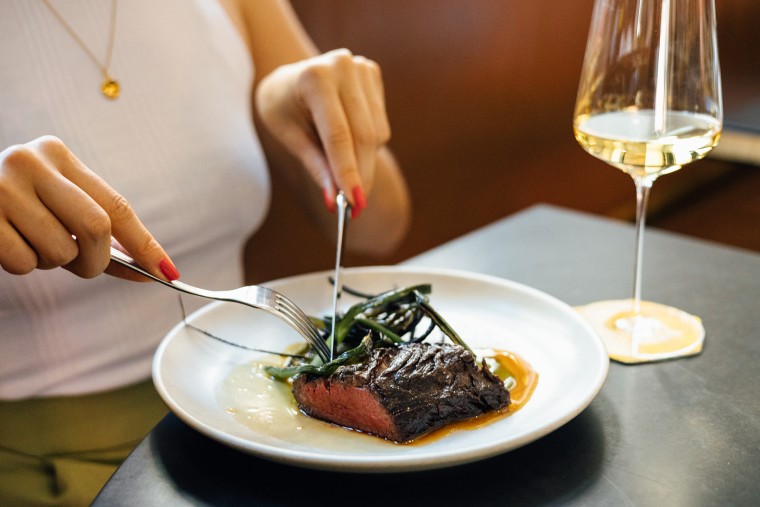 Woman cutting a steak