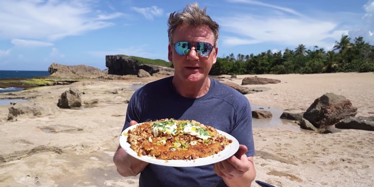 Gordon Ramsay in Puerto Rico, holding a dish he calls "pegao" for an episode of his YouTube series, "Scrambled: On the Road."