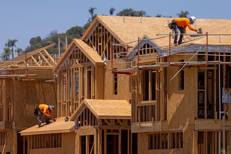 Image: Workers build residential single family homes in Valley Center, Calif., on June 3, 2021.