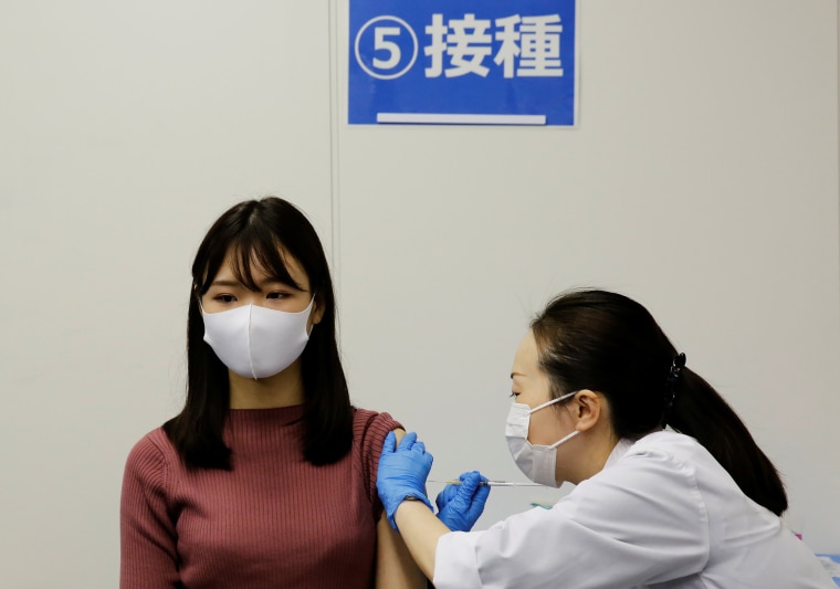 Image: A staff of All Nippon Airways receives a dose of the Moderna Covid-19 vaccine at the company's facility at Haneda airport in Tokyo on June 14, 2021.