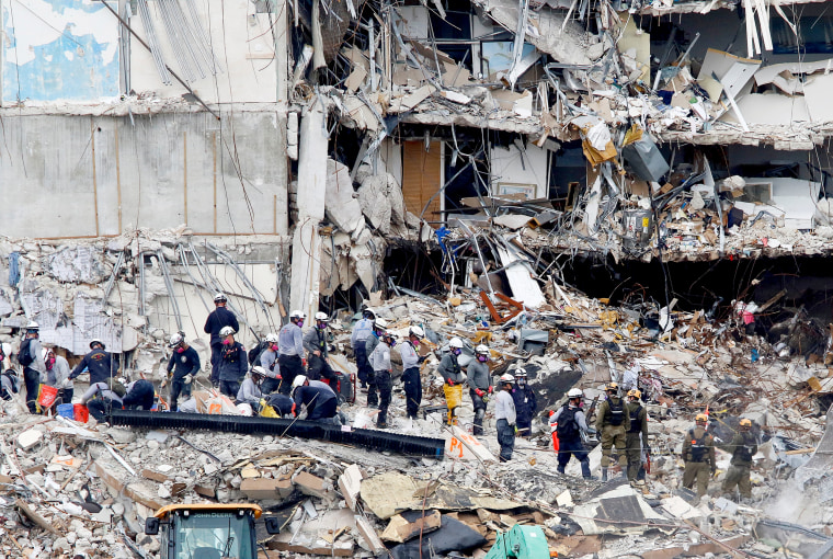 Image: Emergency workers conduct search and rescue efforts at the site of a partially collapsed residential building in Surfside