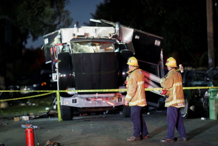 Image: A damaged vehicle is seen at the site of an explosion after police attempted to safely detonate illegal fireworks that were seized, in Los Angeles