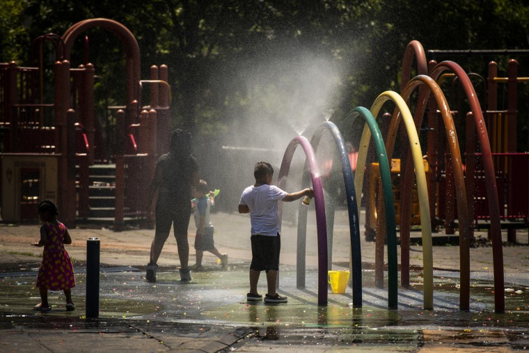 Children play in a splash park during a heat wave in the Brooklyn, N.Y., on June 30, 2021.
