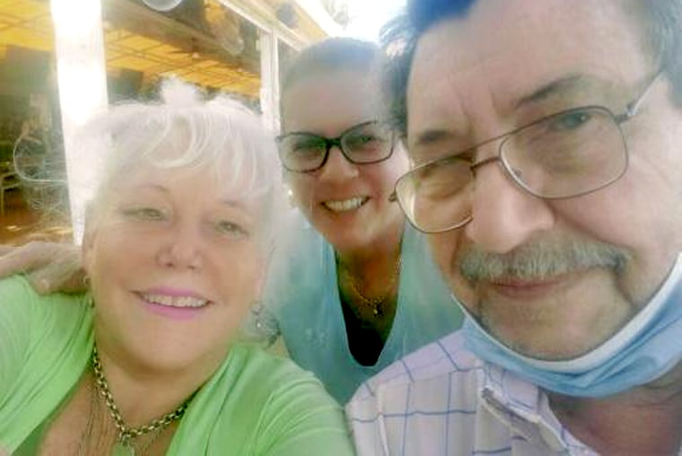 Raysa Rodriguez, center, with her neighbors Dick Augustine and Elaine Sabino, who lived in apartment 1210 and are still unaccounted for.