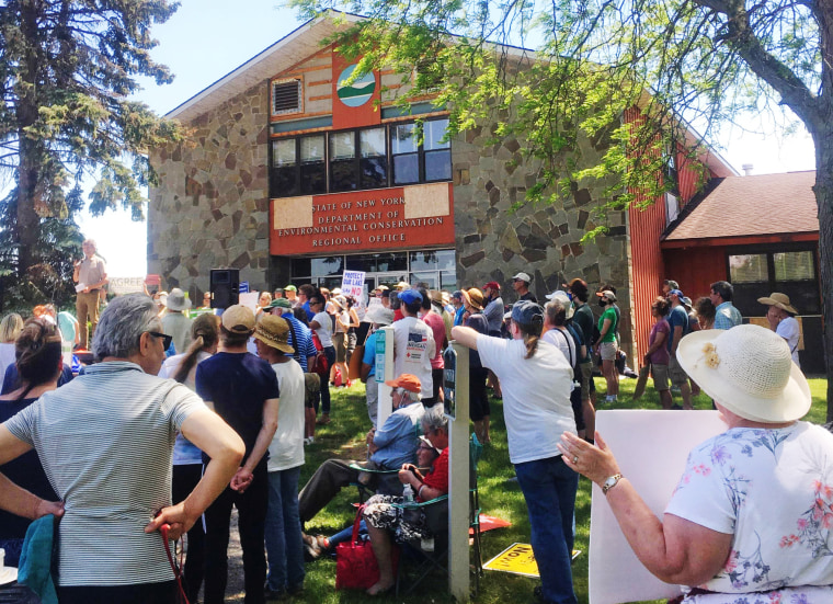 IMAGE: Residents rally against the Greenidge bitcoin mining plant in Avon, N.Y.