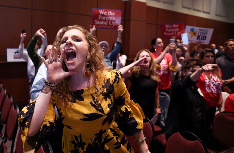Parents and community members protest after a Loudoun County School Board meeting was halted by the school board because the crowd refused to quiet down, in Ashburn, Va., on  June 22, 2021.