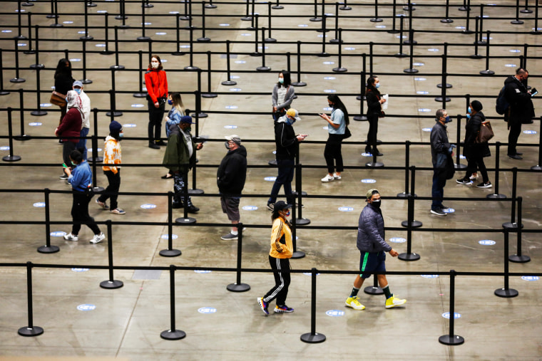 People wait in line to get their vaccine at a coronavirus disease (COVID-19) vaccination site at Lumen Field Event Center in Seattle