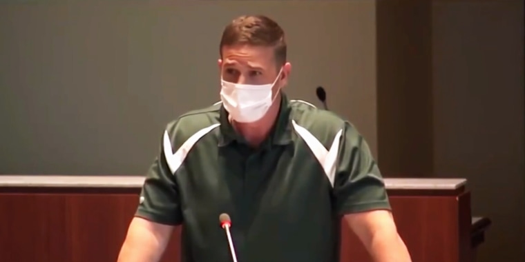 Byron "Tanner" Cross, a physical education teacher at Leesburg Elementary School, speaks at a school board meeting in Loudoun County, Va.