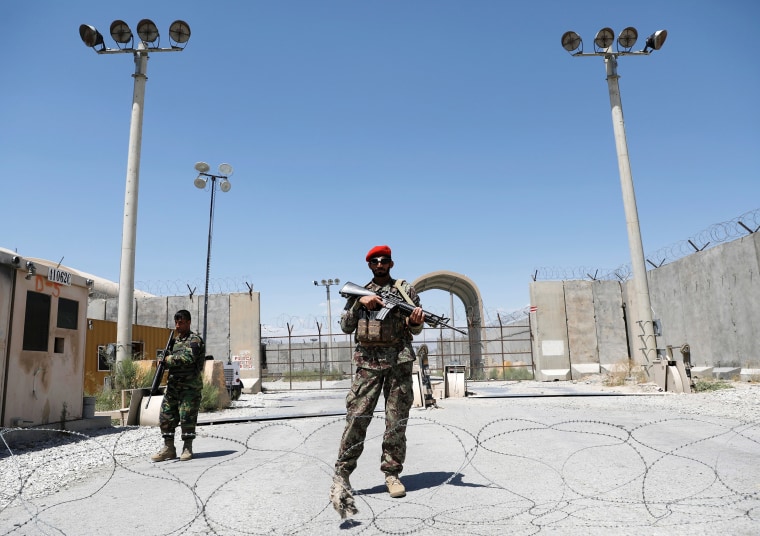 Image: Afghan soldiers stand guard at the gate of Bagram U.S. air base, on the day the last of American troops vacated it, Parwan province, Afghanistan