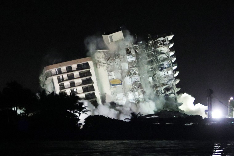 The remaining part of the partially collapsed 12-story Champlain Towers South condo building falls with a controlled demolition on July 4, 2021, in Surfside, Fla.