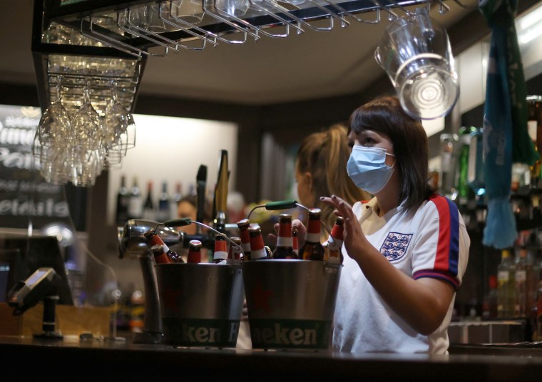 Image: Bar staff serving drinks in The Thistleberry pub, Newcastle-under-Lyme, before the match between England and Ukraine.