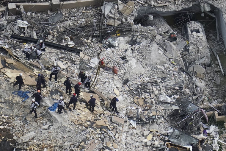 Image: Rescue workers search in the rubble at the Champlain Towers South Condo, in Surfside, Fla., on June 26, 2021.