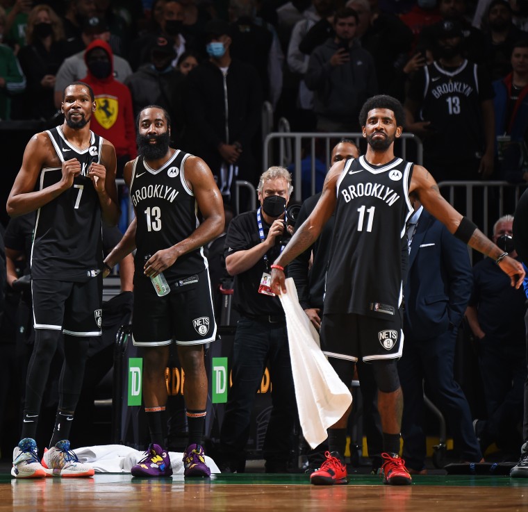 Kevin Durant #7, James Harden #13 and Kyrie Irving #11 of the Brooklyn Nets react to a play during the game against the Boston Celtics during on May 30, 2021, in Boston.