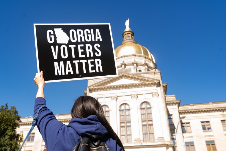 Demonstrators stand outside of the Capitol building in Atlanta on March 3, 2021, to oppose the HB 531 bill that would place restrictions on voting.