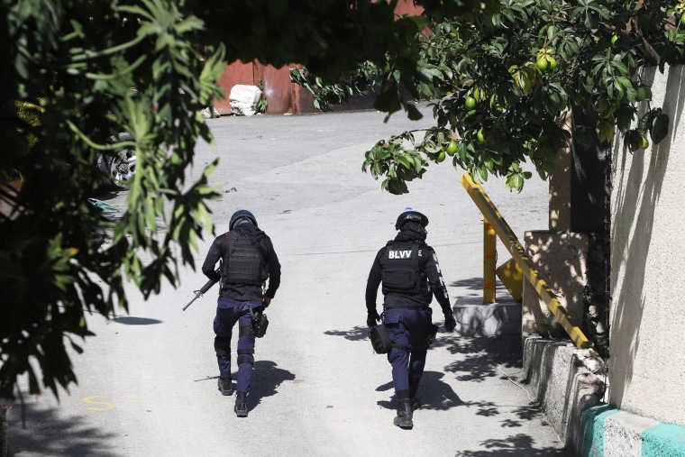 Police officers walk near the private residence of Haitian President Jovenel Moïse after he was shot dead.
