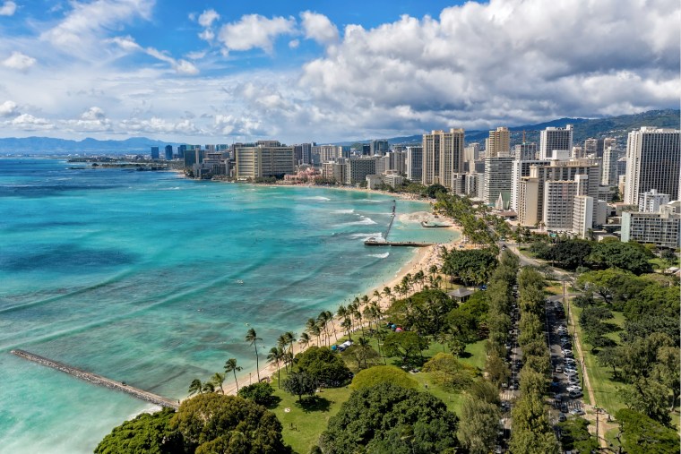 The Waikiki skyline next to Queens Beach in Honolulu.