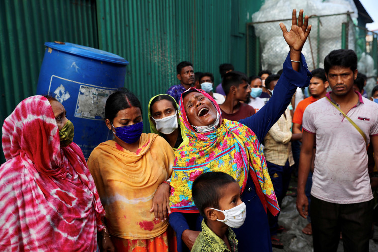 Image: Distraught relatives wait outside the factory on the outskirts of Dhaka on Friday.