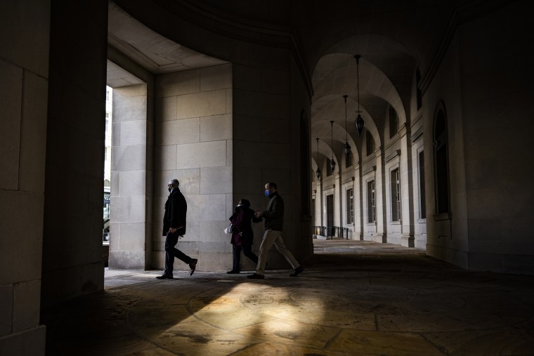Image: Pedestrians walk past the Internal Revenue Service (IRS) headquarters in Washington on March 19, 2021.
