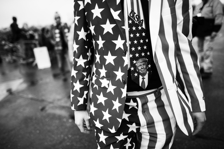 Image: A man wearing a Donald Trump themed tie joins supporters queueing before a rally on Oct. 26, 2020 in Lititz, Pa.