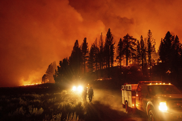 Image: Firefighters battle the Sugar Fire, part of the Beckwourth Complex Fire, burning in Plumas National Forest, Calif., July 8, 2021.