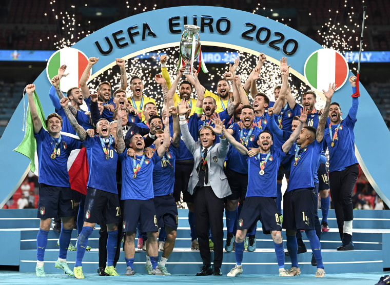 Image: Italy's team celebrates with the trophy on the podium after winning the Euro 2020 soccer championship final between England and Italy at Wembley stadium in London on July 11, 2021.