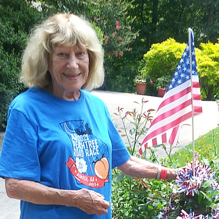 Older woman next to flag