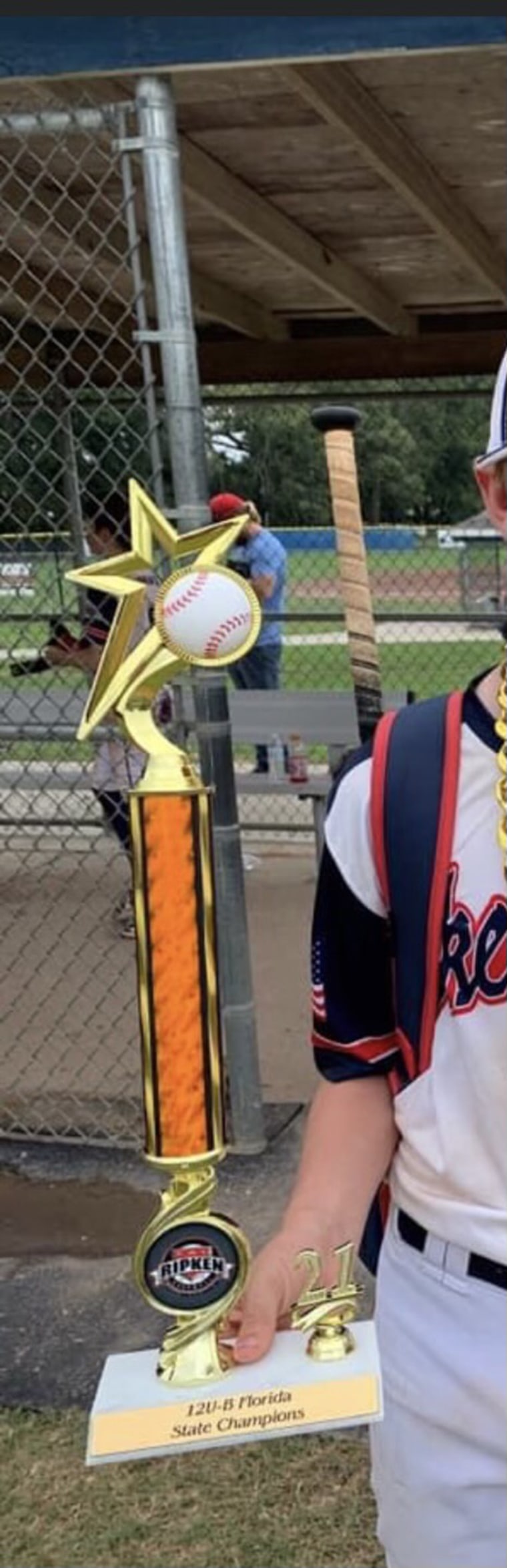 A boy player posed with his trophy. 