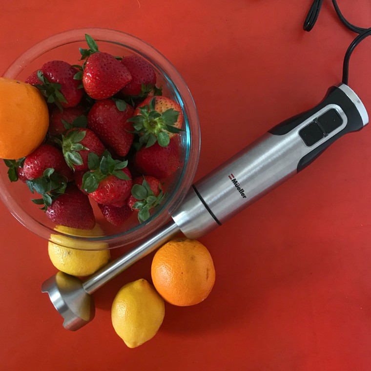 Overhead image of an immersion blender and fruit