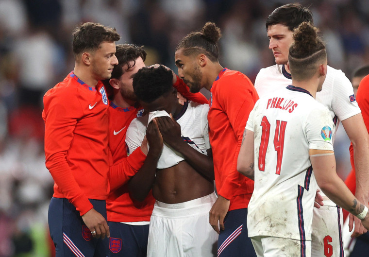 Image: Teammates console Saka after his penalty miss