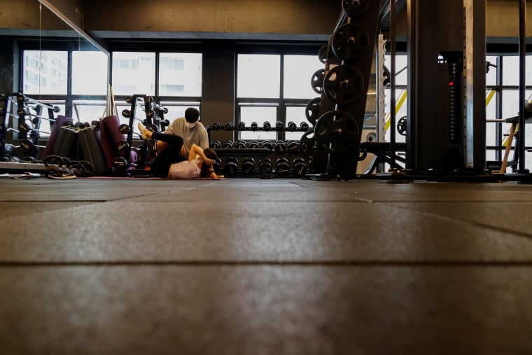 Image: A gym member trains in a fitness club in Seoul, South Korea