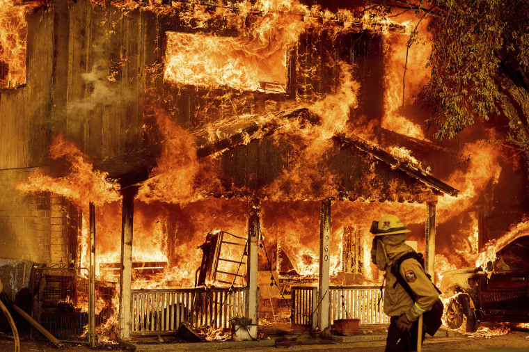 Image: Fire consumes a home as the Sugar Fire, part of the Beckwourth Complex Fire, tears through Doyle, Calif., on July 10, 2021.