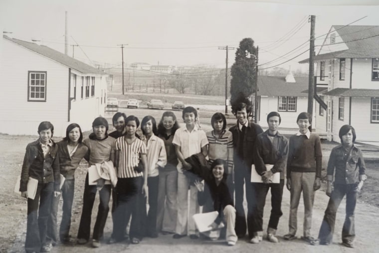 Educator Shelly Beaser pictured with 13 of the Vietnamese and Cambodian refugees she taught in Indiantown Gap, Pennsylvania during "Operation New Life." 1975.